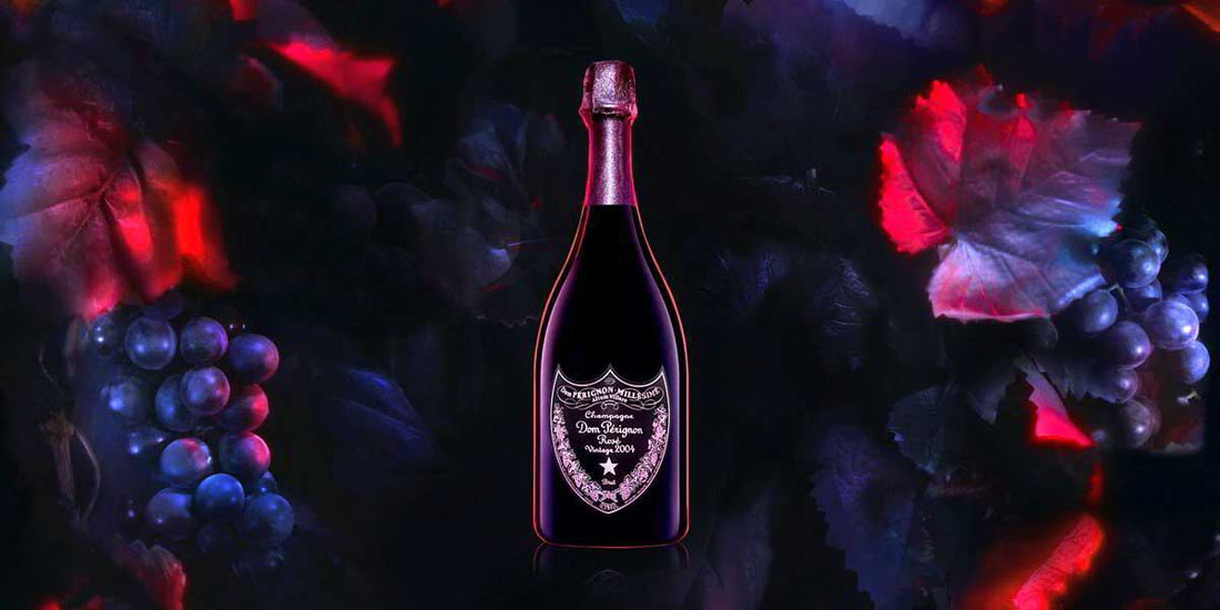 Dom Perignon Rose champagne bottle with dark grapes and leaves background