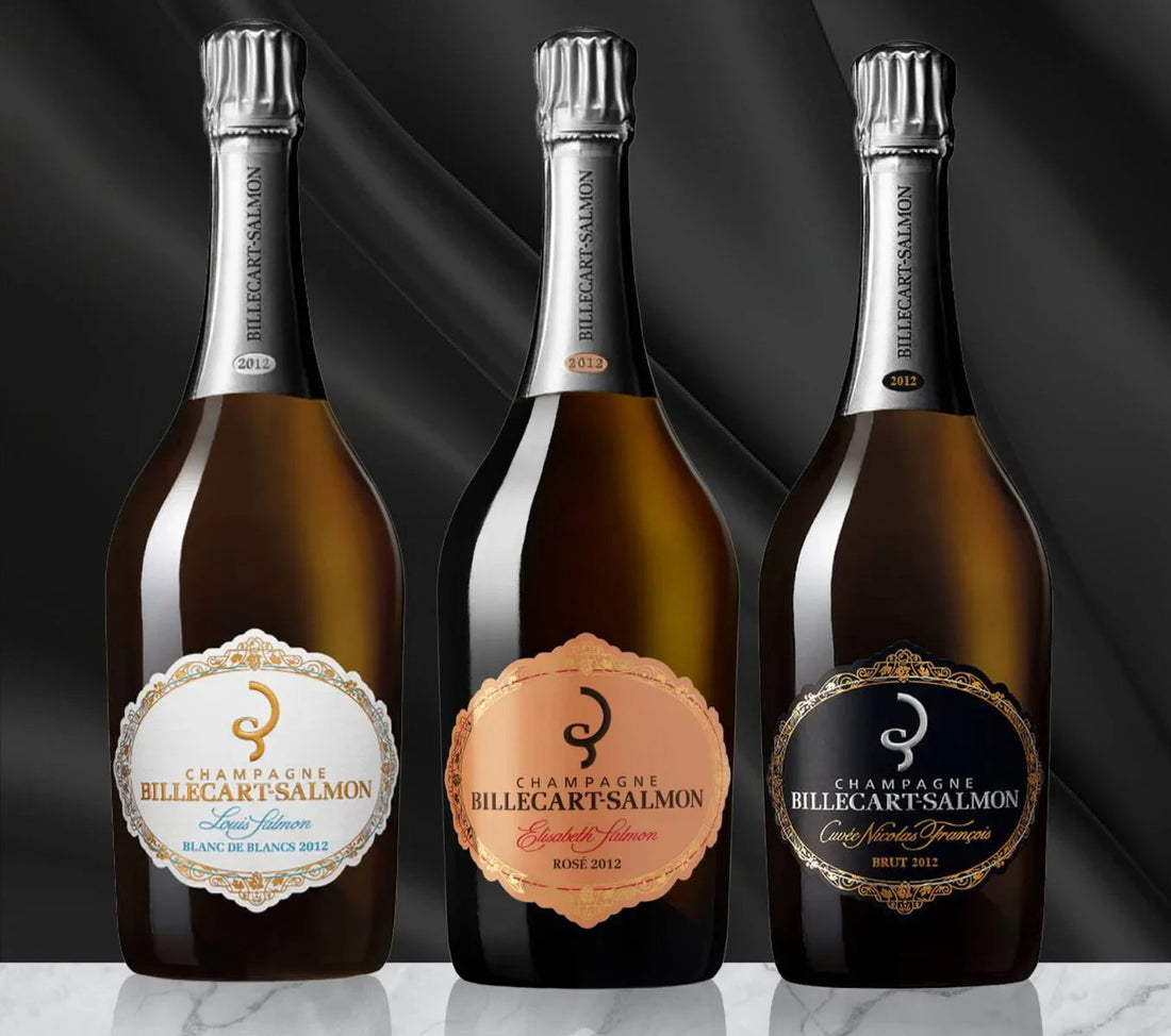 Three Billecart-Salmon 2012 champagne bottles—Blanc de Blancs, Rosé, and Brut—on marble.
