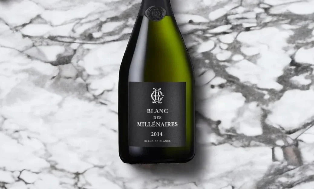 Blanc des Millénaires 2014 champagne bottle on white marble surface