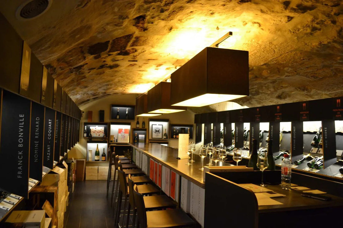 Paris wine bar interior with stone ceiling, wine bottles, and tasting glasses on counter