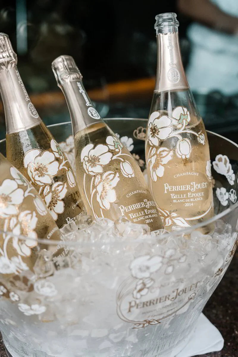 Perrier-Jouët Belle Epoque champagne bottles in ice bucket, floral design, close-up