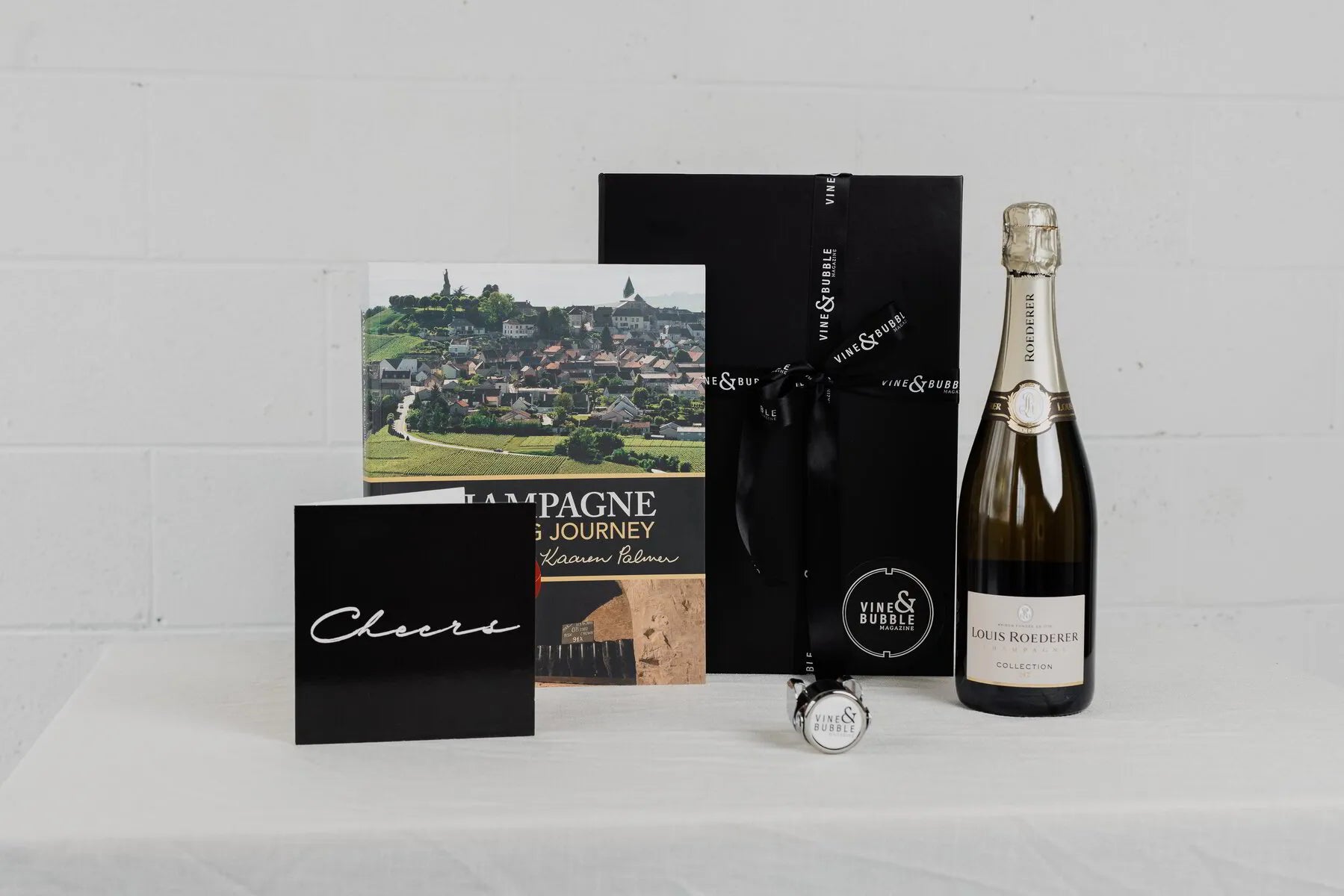 Louis Roederer Collection 242 Champagne book gift pack with bottle and gift box on table