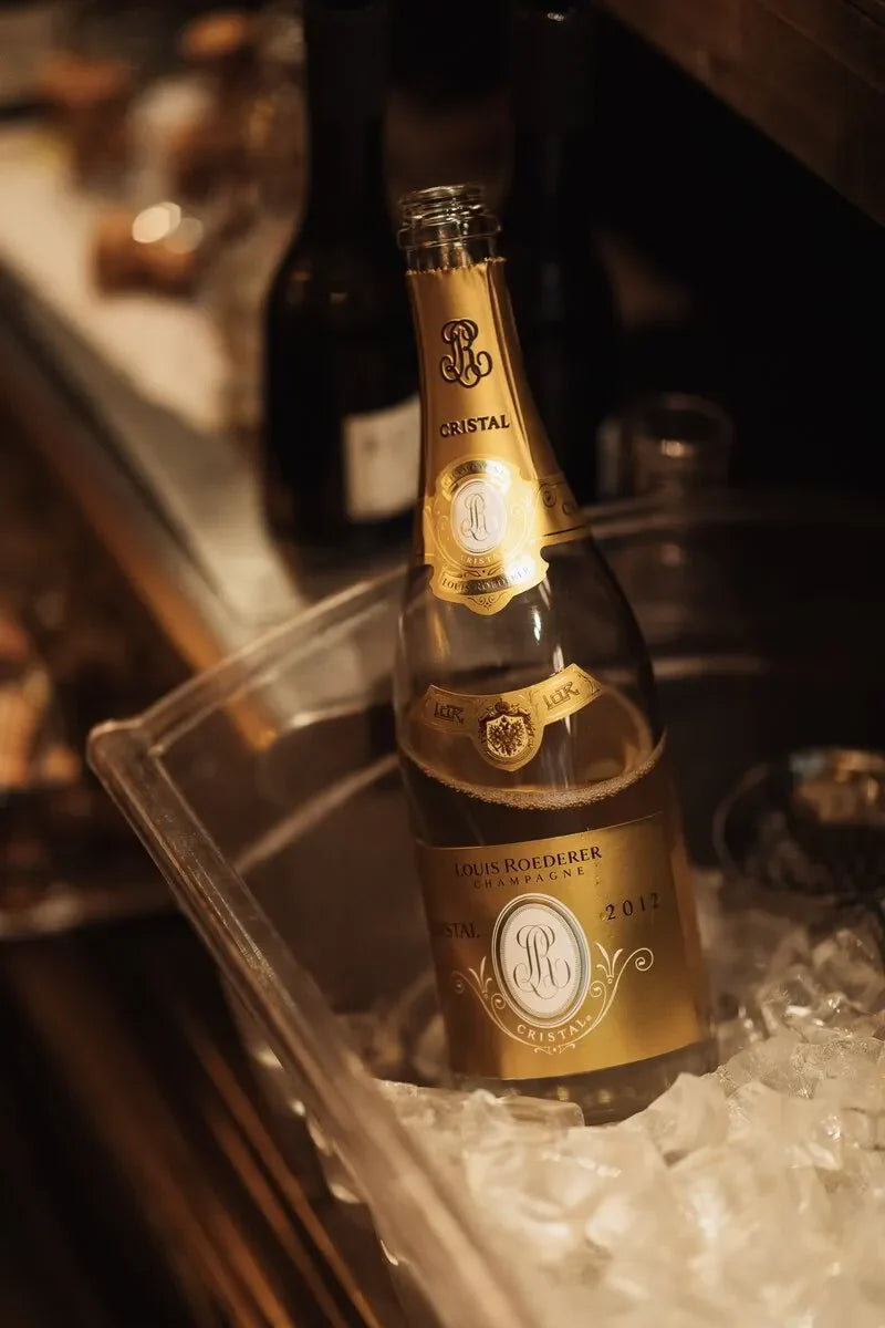 Louis Roederer Cristal champagne bottle in ice bucket at upscale bar setting