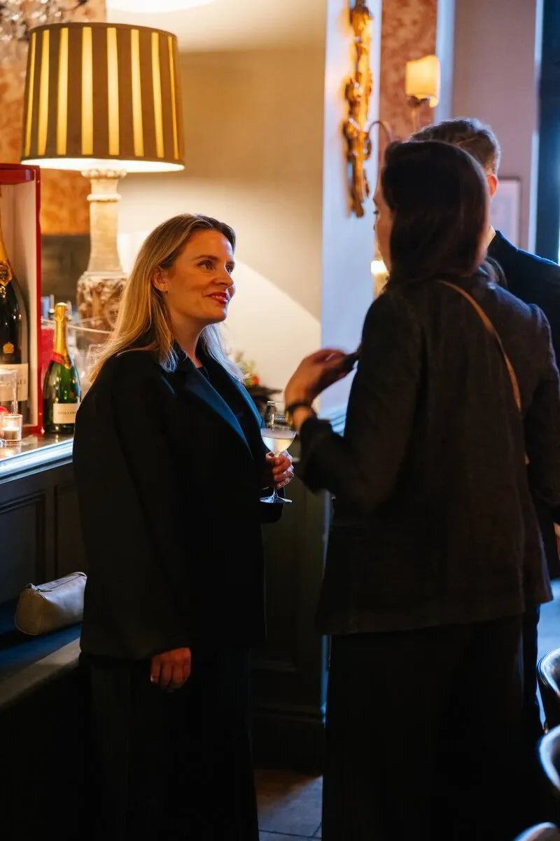 Guests enjoy Bollinger champagne during a caviar pairing dinner event in Sydney, October 2024.