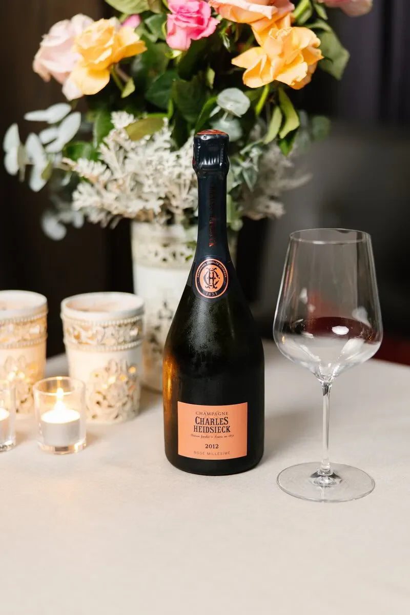 Charles Heidsieck Rosé Millésime Champagne 2012 on a dining table. An elegant wine pairing dinner experience.