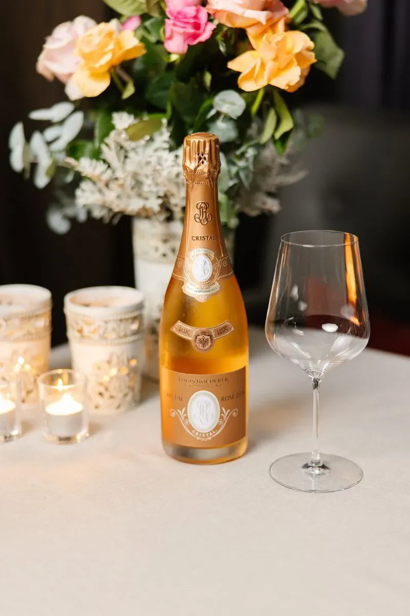 Elegant rosé champagne setting for a luxury wine dinner, featuring Cristal Louis Roederer.