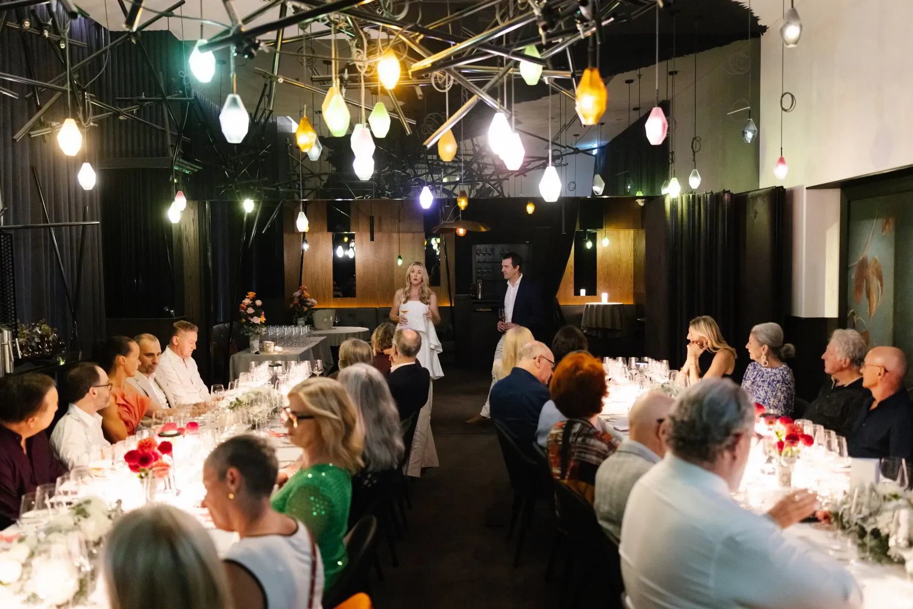 Elegant rosé champagne dinner event in Sydney, March 2025. Guests seated at a long table, enjoying fine dining and a