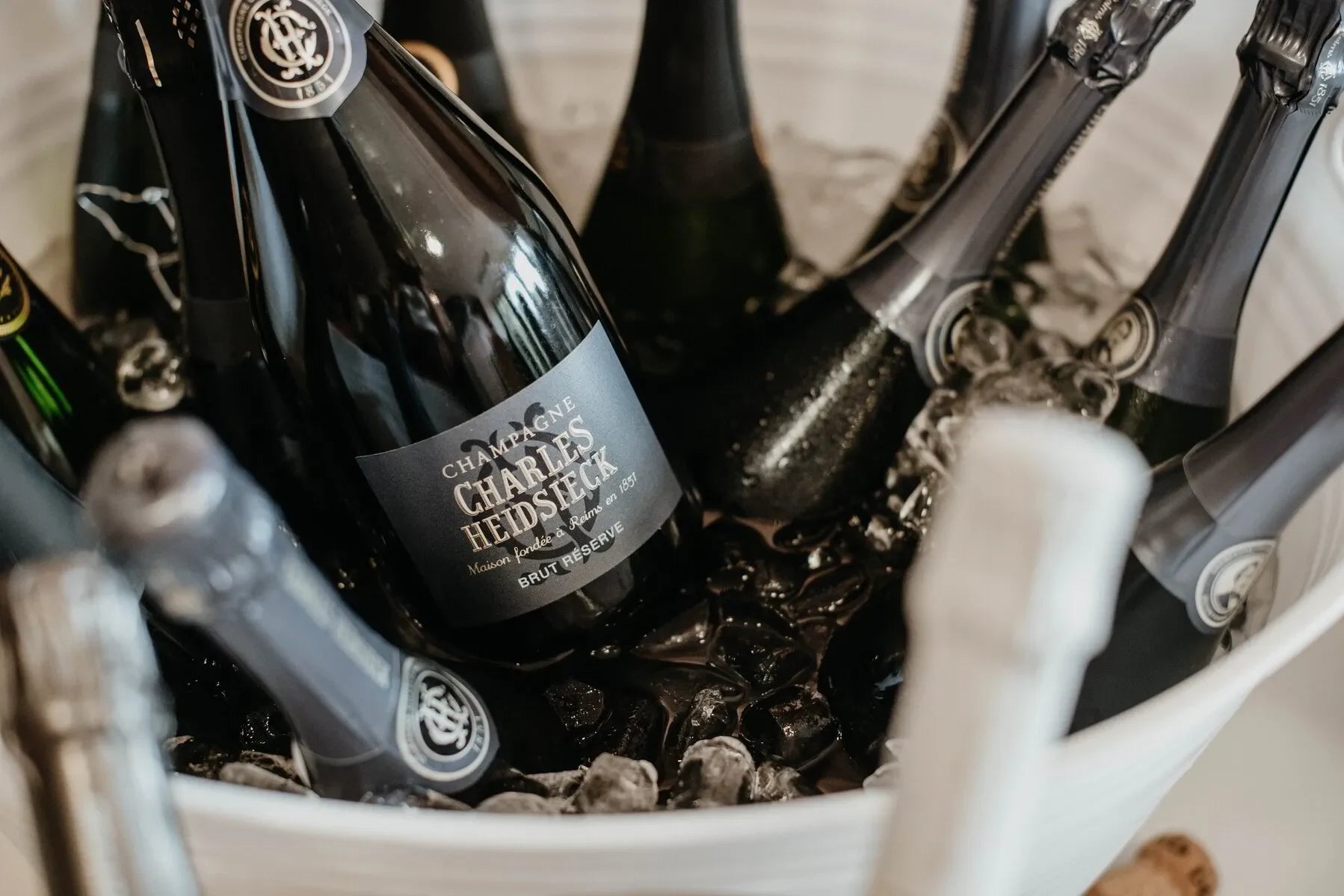 Charles Heidsieck champagne bottles chilled in ice in a white bucket