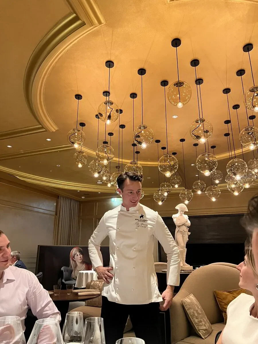 Chef presenting Royal Champagne's champagne selection, part of France's Le Printemps des Champagnes event in April 2024.