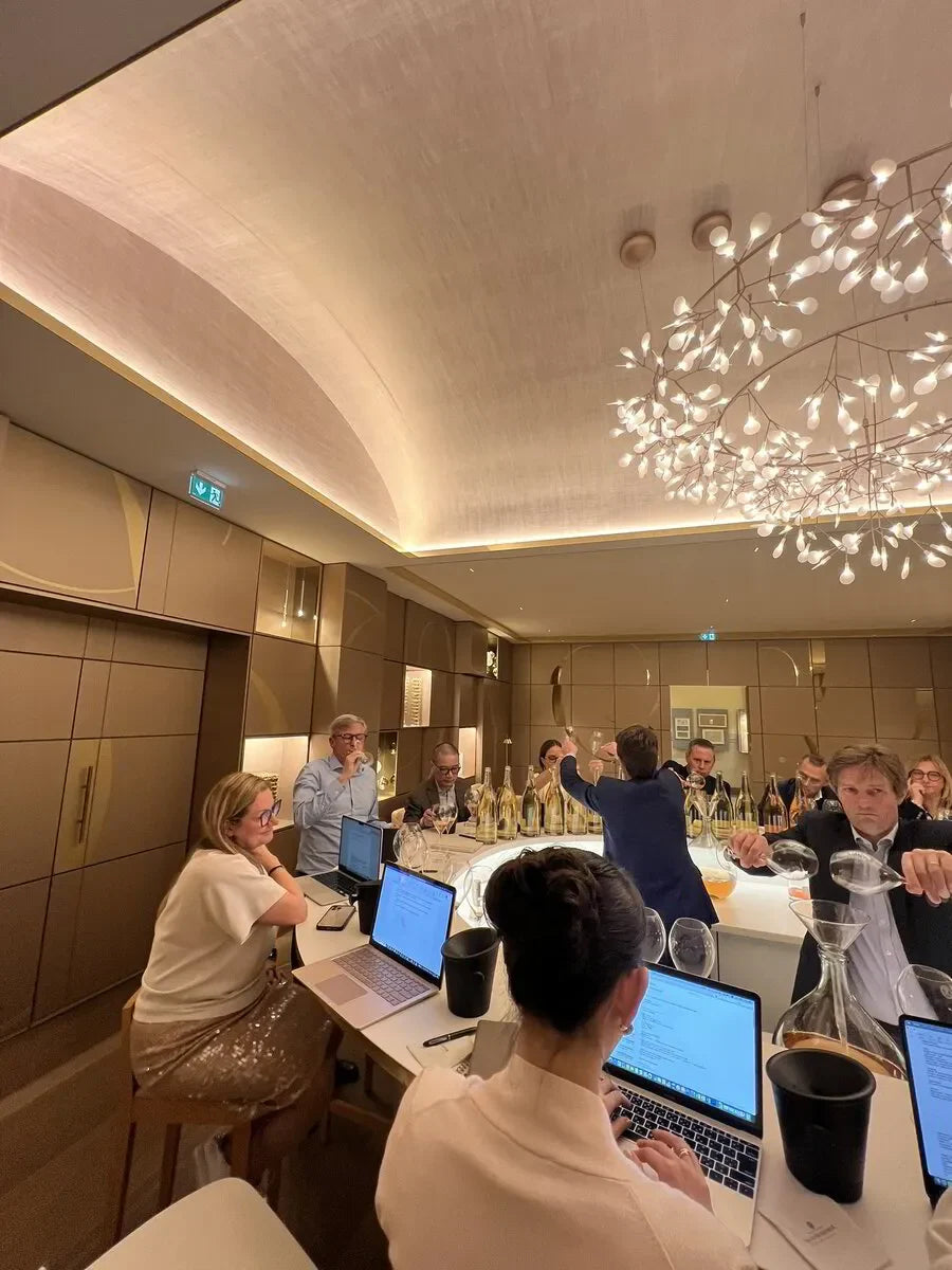 Wine experts during the "Le Printemps des Champagnes" tasting event in Champagne, France, April 2024, with notebooks and