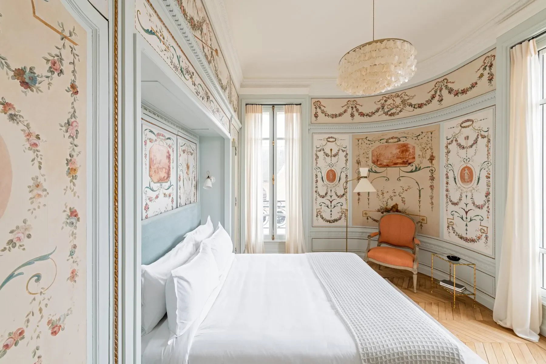Luxurious suite in Champagne, France VIP tour accommodation; note ornate wall art, double bed.