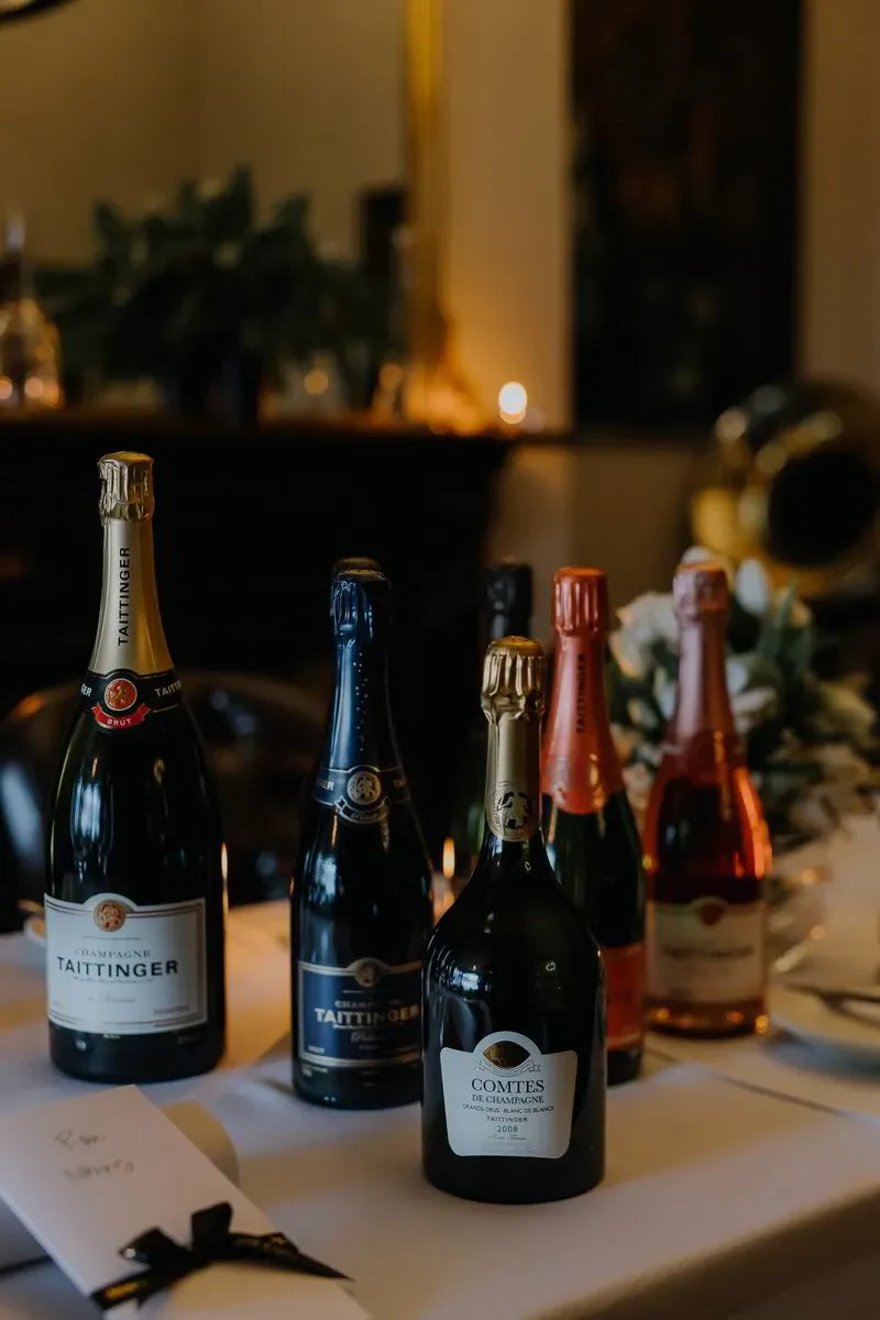 Taittinger champagne bottles displayed on elegant dinner table with floral decor