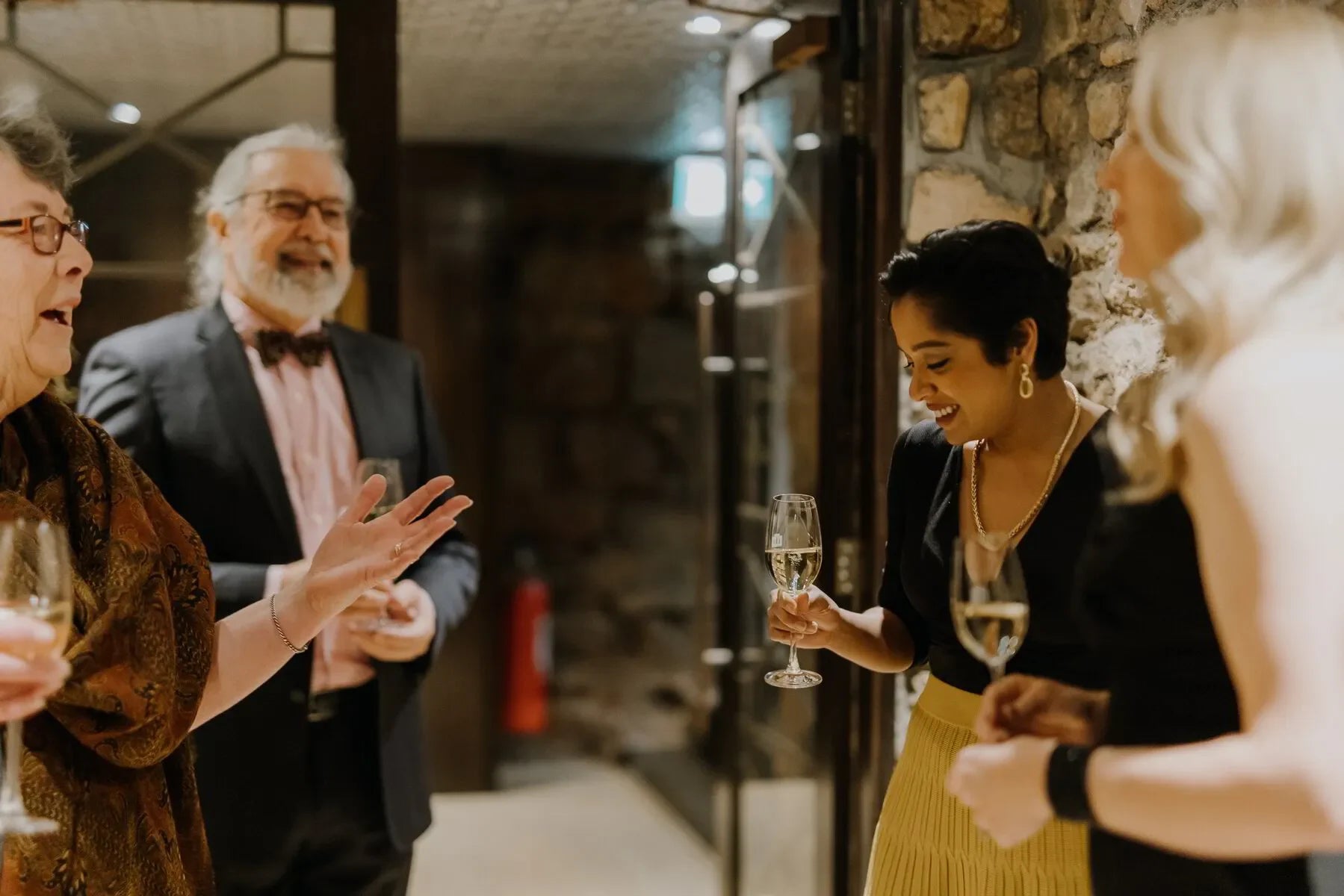 Group of people enjoying wine at a Taittinger dinner in Adelaide stone cellar